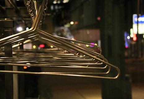 Coat hangers hanging on a rail at coat check