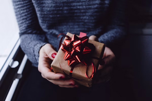 a person holding a wrapped present